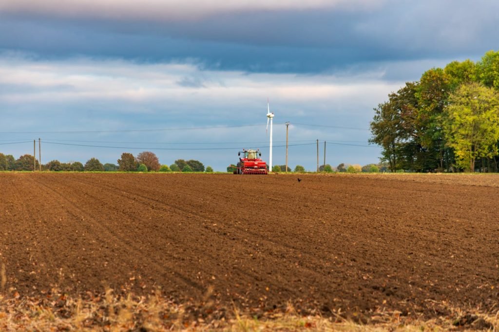 tractor-plowing-field-with-wind-turbine-in-background-34335819 tractor-plowing-field-with-wind-turbine-in-background-34335819